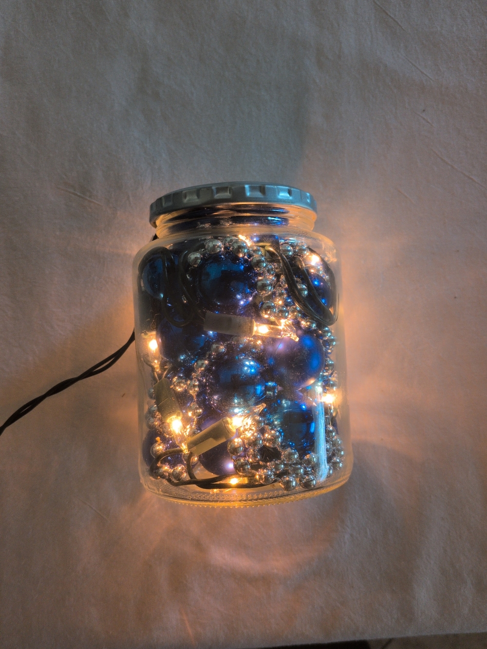 Holiday Glass Jar of Blue Ornaments and Lights - Home Holiday